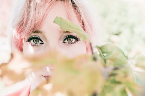 Closeup of women's Eyes behind a plant