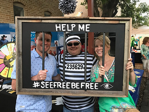 Dr.Parkhurst with 2 Employees behind a frame with bars