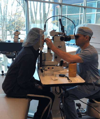 women receiving eye exam exam from doctor