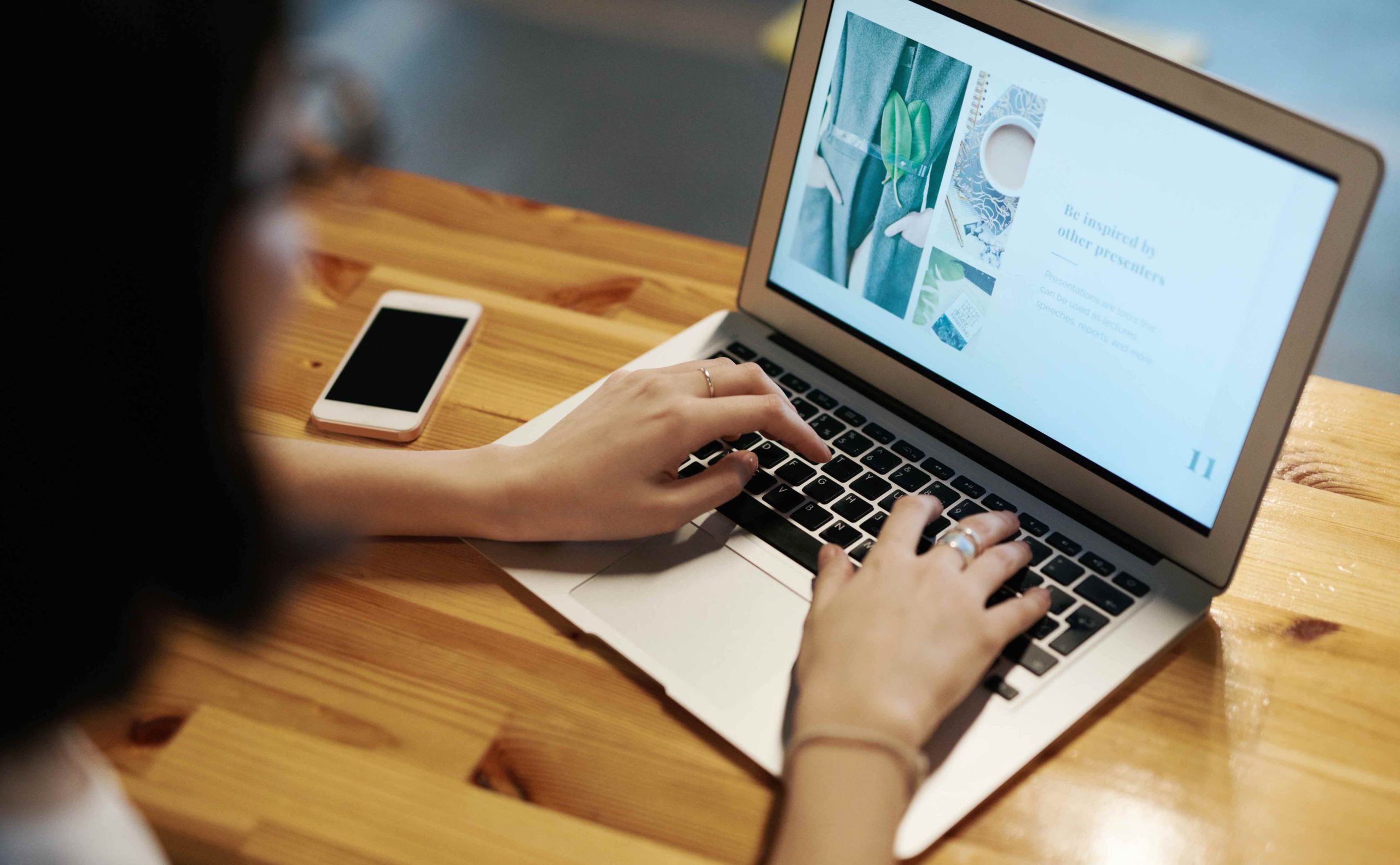 women typing on laptop