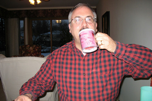 dad in plaid shirt drinking from mug