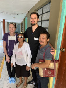 Mission Trip team members take a snapshot with a happy patient