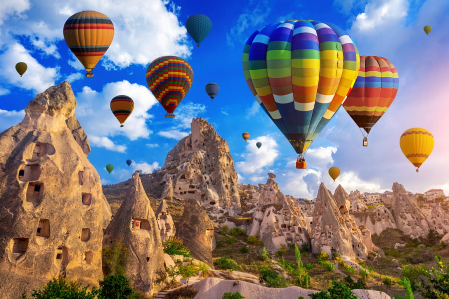 Hot air balloons flying over beautiful landscape