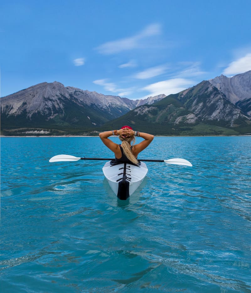 woman riding a kayak on a beautiful lake