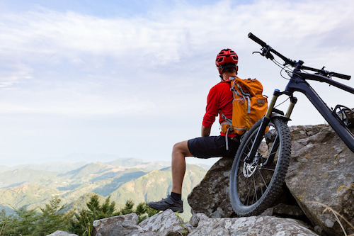 male mountain biker looking towards the horizon with vision fixed and restored
